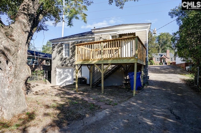 rear view of property with central air condition unit and a deck