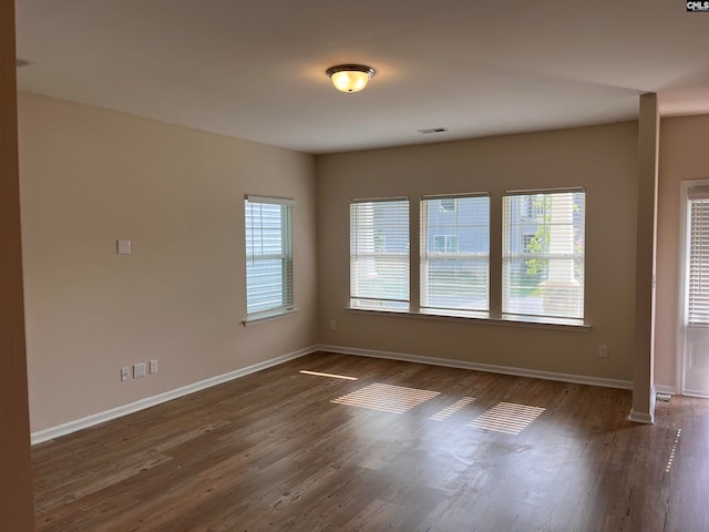 empty room featuring dark hardwood / wood-style flooring