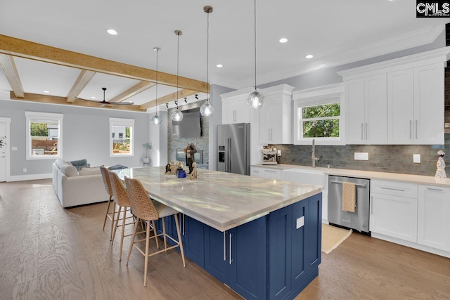 kitchen featuring light hardwood / wood-style floors, white cabinets, and stainless steel appliances