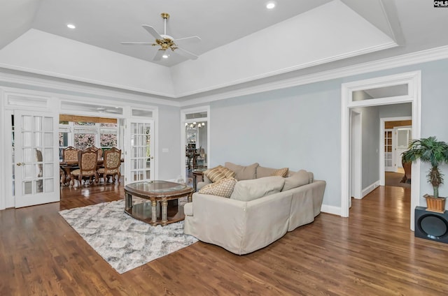 living room with ceiling fan and a tray ceiling