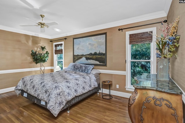 bedroom featuring multiple windows, hardwood / wood-style floors, crown molding, and ceiling fan