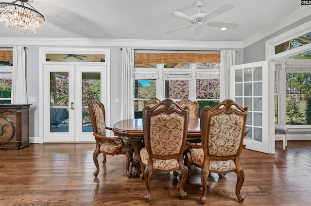 dining space featuring crown molding, dark wood-type flooring, french doors, and ceiling fan with notable chandelier