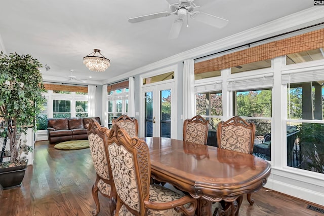 dining space with ceiling fan with notable chandelier, ornamental molding, hardwood / wood-style floors, and french doors