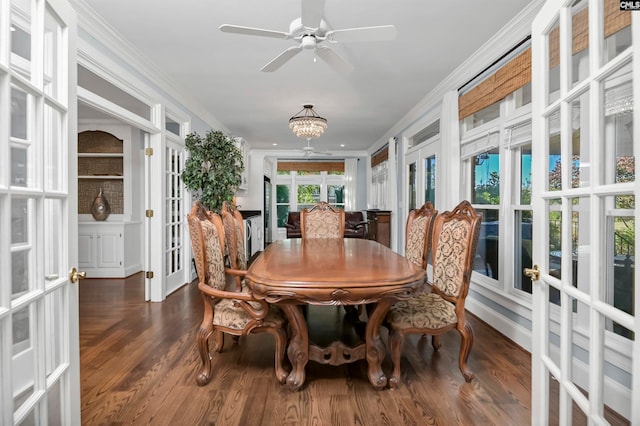 dining area featuring ornamental molding, dark hardwood / wood-style floors, ceiling fan with notable chandelier, and french doors