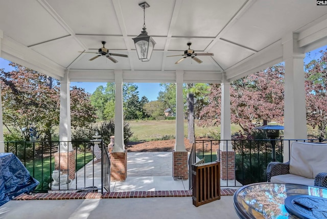 sunroom / solarium with plenty of natural light, coffered ceiling, and ceiling fan