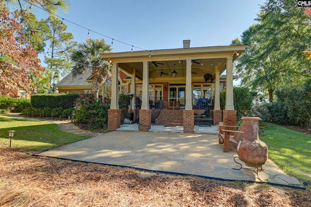 exterior space with a patio area, ceiling fan, and a lawn