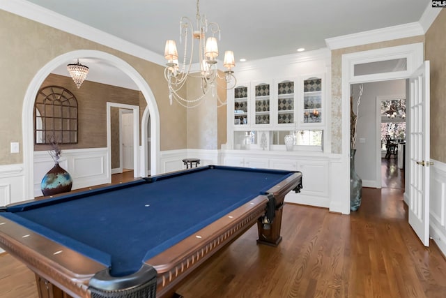 playroom with ornamental molding, dark hardwood / wood-style floors, and an inviting chandelier