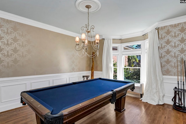 game room featuring an inviting chandelier, pool table, ornamental molding, and dark hardwood / wood-style flooring