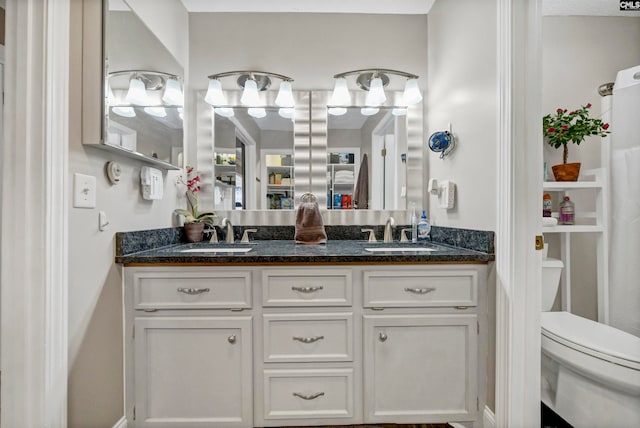 bathroom featuring vanity and toilet