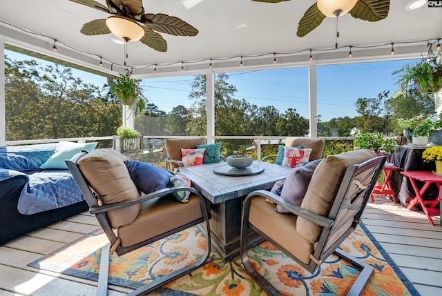 sunroom / solarium with track lighting and ceiling fan