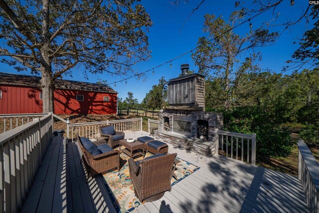 wooden terrace featuring an outdoor living space with a fireplace