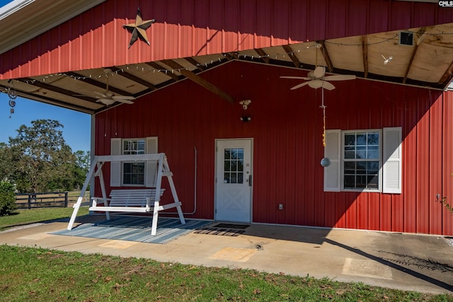 doorway to property featuring ceiling fan