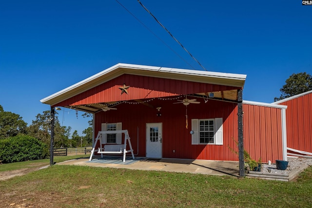 rear view of property featuring a yard, a patio, and ceiling fan