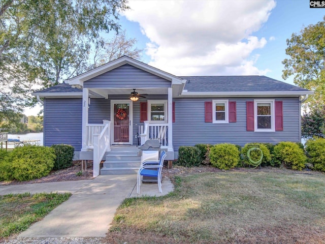 view of front facade with a front yard, a porch, and ceiling fan