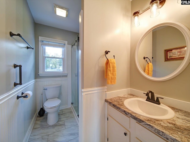 22 Garden Spot Rd, Camden, SC 29020 - full bath featuring marble look tile flooring, toilet, vanity, wainscoting, and a shower with door
