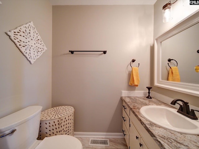 bathroom with vanity and toilet