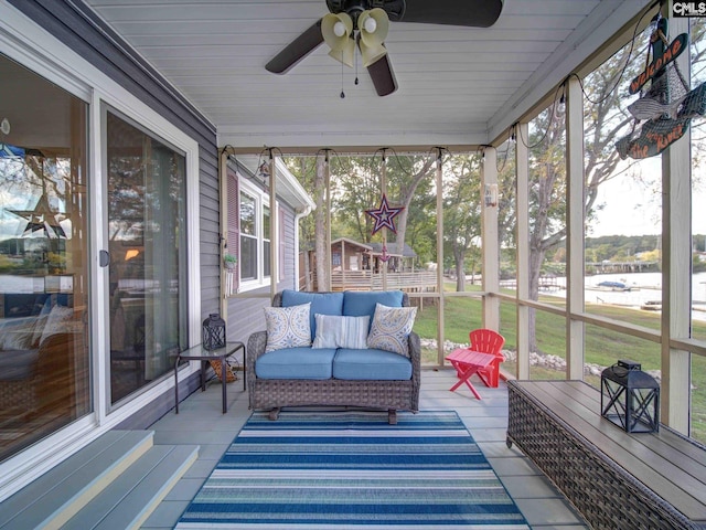 sunroom featuring ceiling fan and wooden ceiling