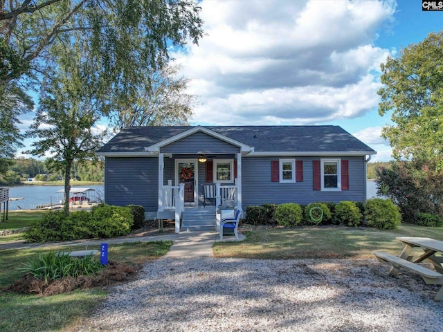 22 Garden Spot Rd, Camden, SC 29020 - view of front of house with a porch, a water view, roof with shingles, and a front lawn