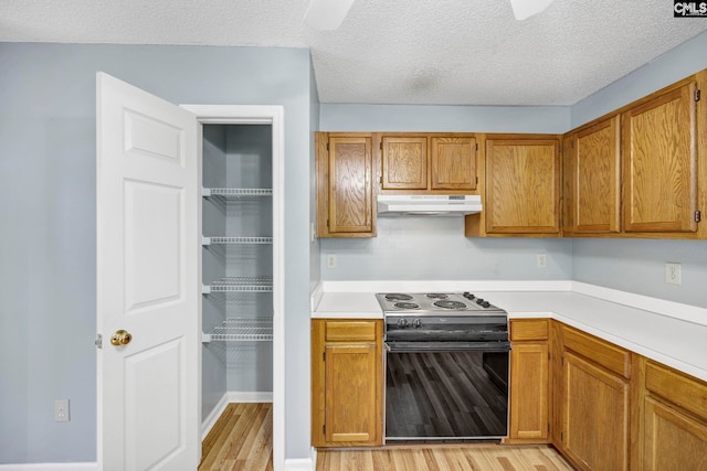 kitchen with black range with electric cooktop, a textured ceiling, and light hardwood / wood-style floors