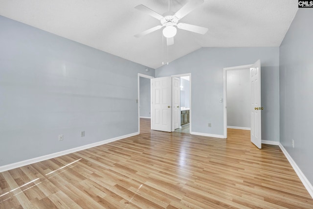 unfurnished bedroom with light hardwood / wood-style floors, connected bathroom, vaulted ceiling, and ceiling fan