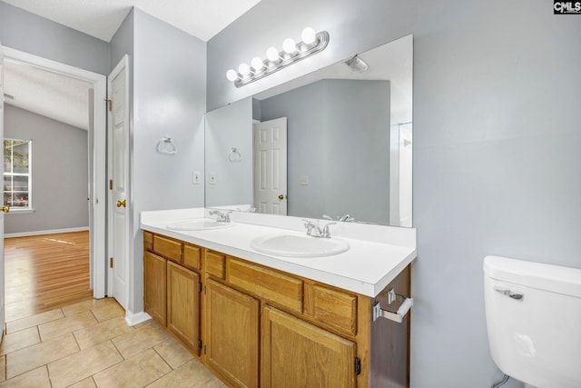 bathroom featuring vanity, toilet, and hardwood / wood-style flooring