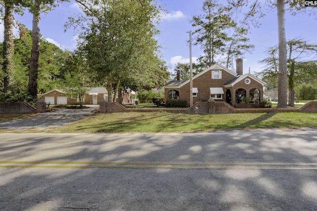 6560 Voorhees Rd, Denmark, SC 29042 - view of front facade with a chimney, a front lawn, brick siding, and driveway