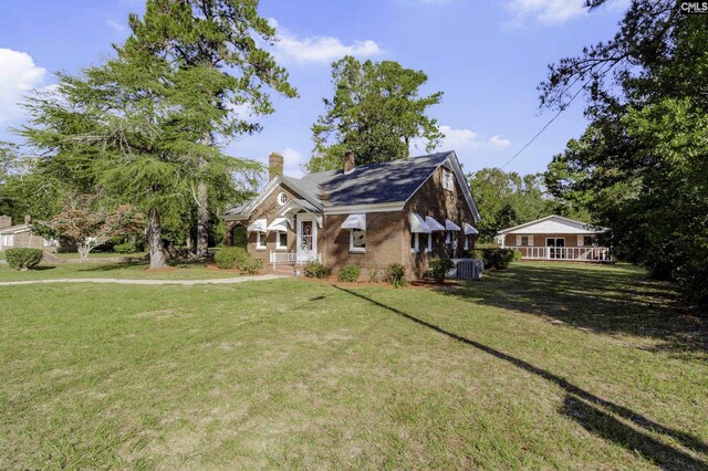 6560 Voorhees Rd, Denmark, SC 29042 - view of front of house featuring a chimney, a front yard, and brick siding
