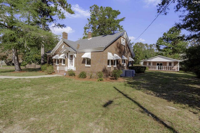 6560 Voorhees Rd, Denmark, SC 29042 - view of home's exterior with a yard, brick siding, a chimney, and a porch