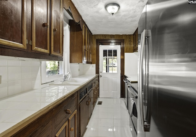 6560 Voorhees Rd, Denmark, SC 29042 - kitchen with freestanding refrigerator, tile counters, decorative backsplash, light tile patterned floors, and range