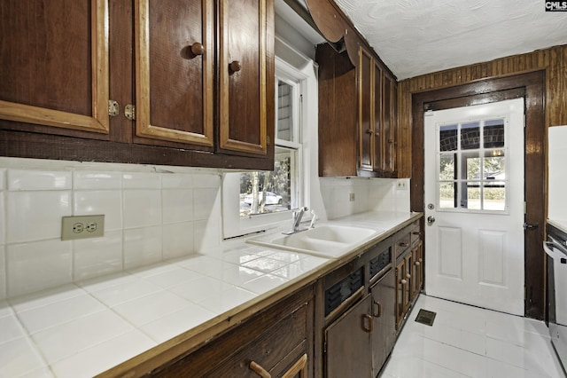 6560 Voorhees Rd, Denmark, SC 29042 - kitchen with tile countertops, decorative backsplash, and dark brown cabinets