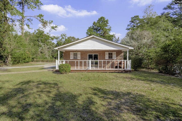 6560 Voorhees Rd, Denmark, SC 29042 - view of front of house with brick siding, a front lawn, and a wooden deck