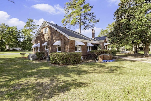 6560 Voorhees Rd, Denmark, SC 29042 - view of side of home with brick siding, a chimney, and a lawn