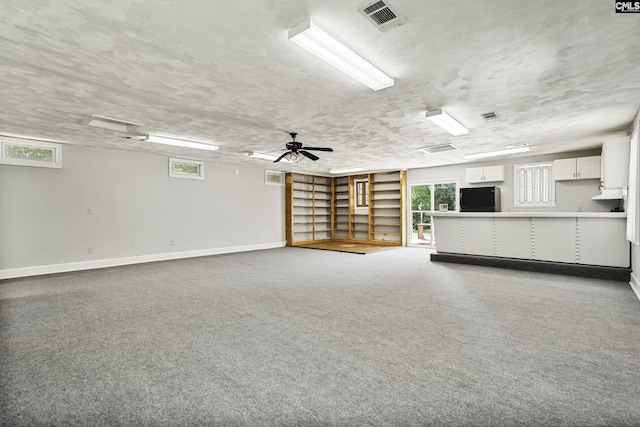 6560 Voorhees Rd, Denmark, SC 29042 - unfurnished living room featuring carpet floors, a textured ceiling, and a ceiling fan