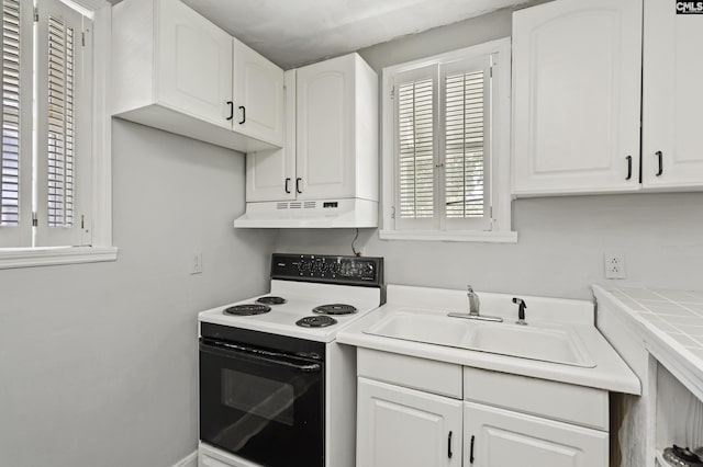 6560 Voorhees Rd, Denmark, SC 29042 - kitchen featuring electric range, under cabinet range hood, plenty of natural light, and white cabinets