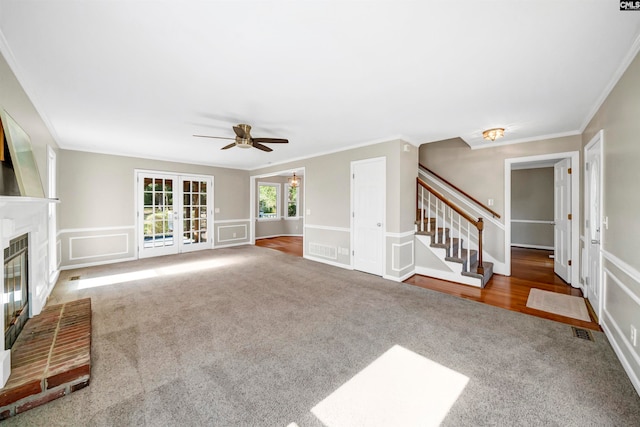 unfurnished living room featuring crown molding, a fireplace, and carpet floors