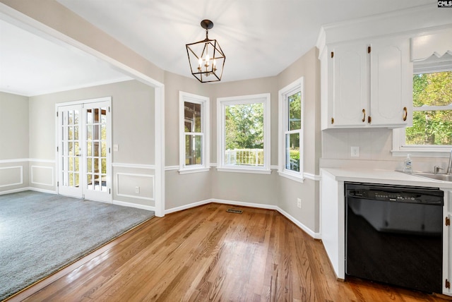 unfurnished dining area with a chandelier and light wood-type flooring