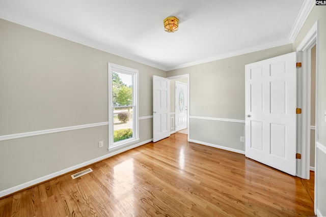 unfurnished bedroom with crown molding and light hardwood / wood-style floors