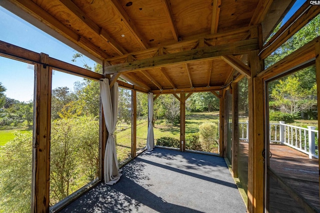 unfurnished sunroom with lofted ceiling and a wealth of natural light