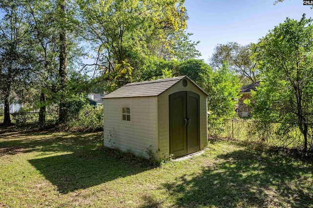 view of outbuilding with a lawn