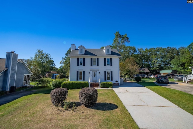 colonial home with a front lawn