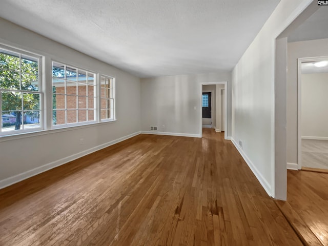 6731 Formosa Dr, Columbia, SC 29206 - empty room with wood-type flooring, a wealth of natural light, baseboards, and visible vents