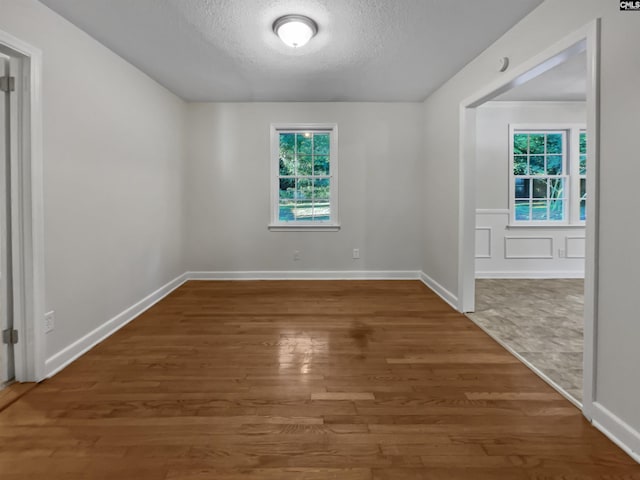 6731 Formosa Dr, Columbia, SC 29206 - spare room with baseboards, wood finished floors, and a textured ceiling