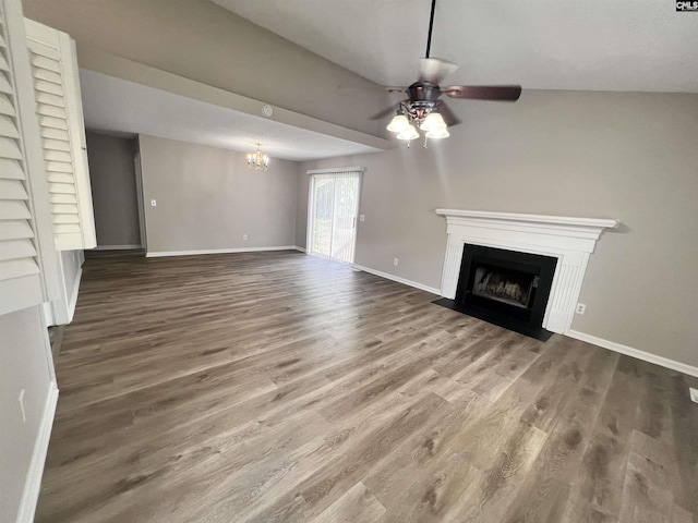 unfurnished living room with hardwood / wood-style flooring and ceiling fan with notable chandelier