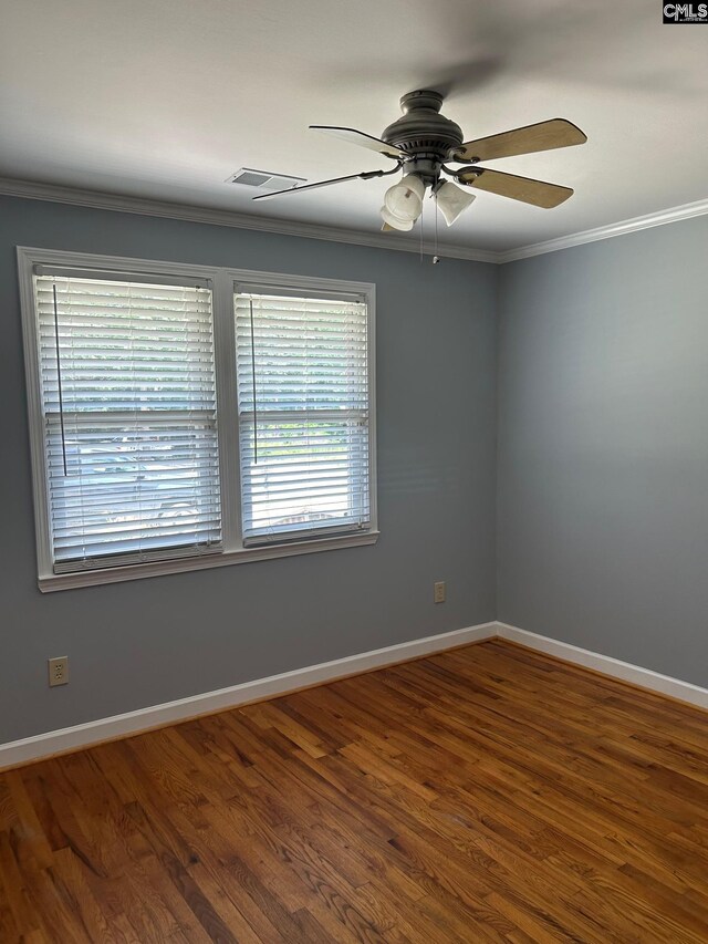 unfurnished room featuring crown molding, hardwood / wood-style floors, ceiling fan, and a wealth of natural light