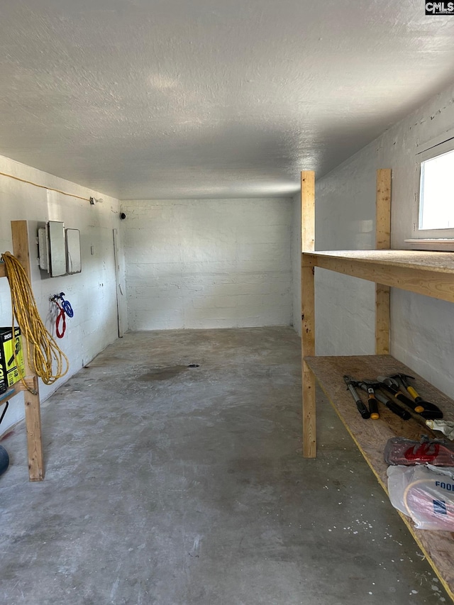 basement featuring a textured ceiling