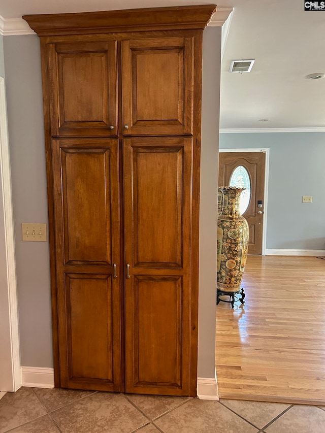 interior details featuring crown molding and wood-type flooring