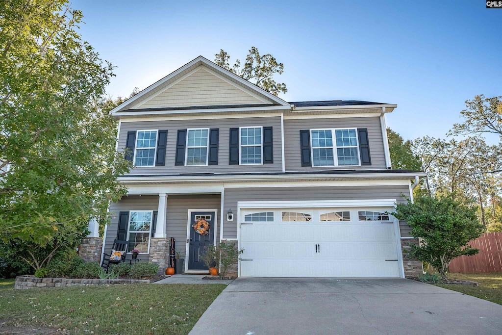 view of front of house featuring a front yard and a garage