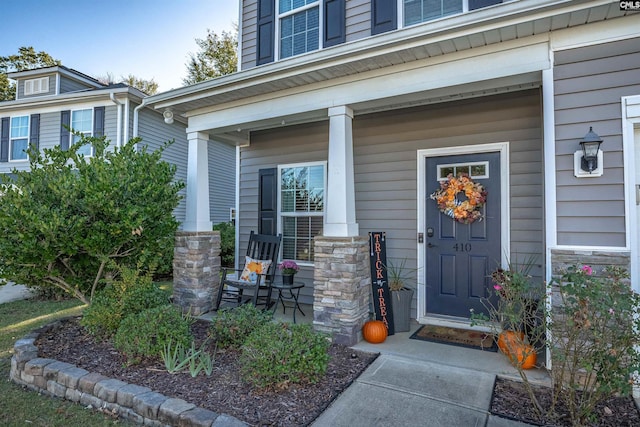 view of exterior entry with a porch