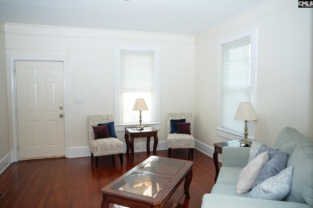 living room with a wealth of natural light, ornamental molding, and dark hardwood / wood-style floors