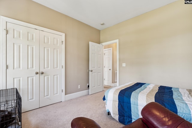 bedroom featuring light colored carpet and a closet